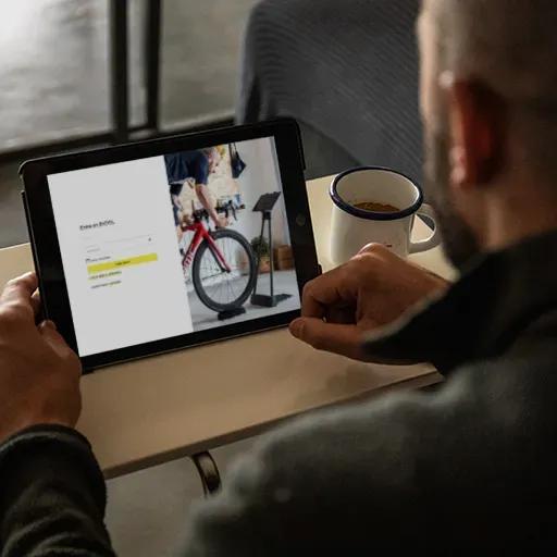 Uomo che si registra come utente del simulatore di bicicletta BKOOL sul suo computer.